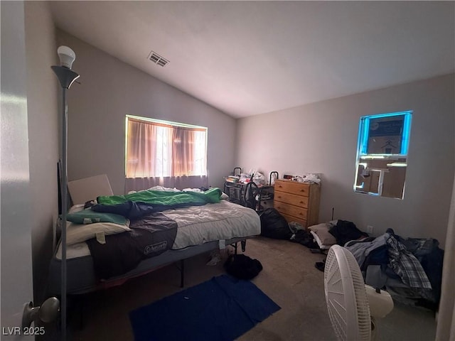 bedroom with lofted ceiling and carpet