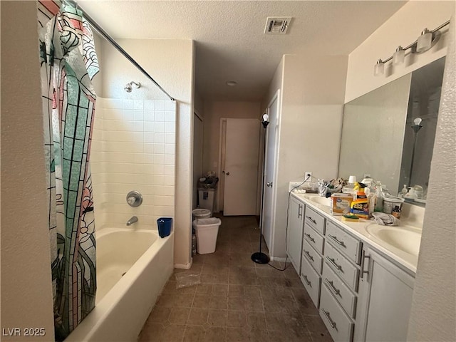full bathroom with a textured ceiling, double vanity, shower / bath combination with curtain, toilet, and tile patterned floors