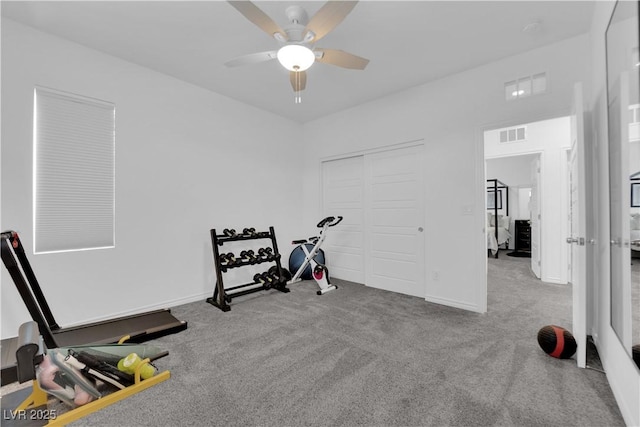 workout area with a ceiling fan, carpet floors, and baseboards