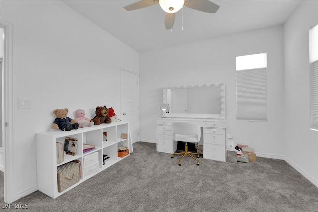 carpeted office featuring ceiling fan and baseboards