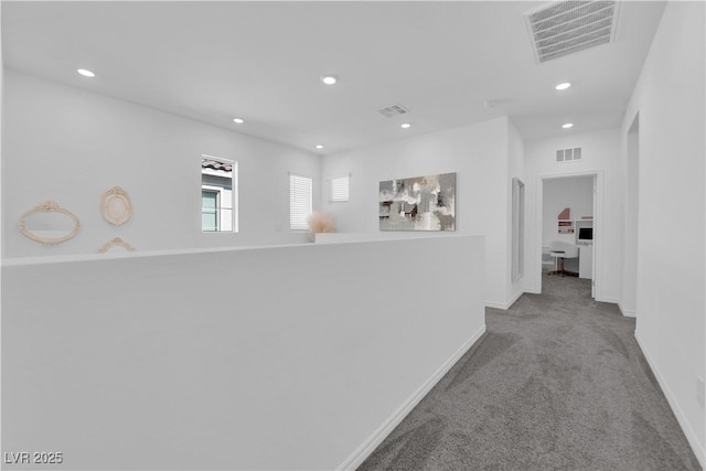 hall with carpet flooring, recessed lighting, and baseboards