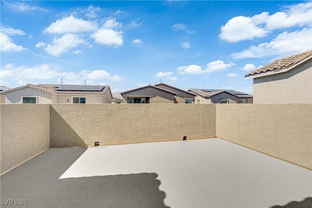 view of patio / terrace with a residential view and fence