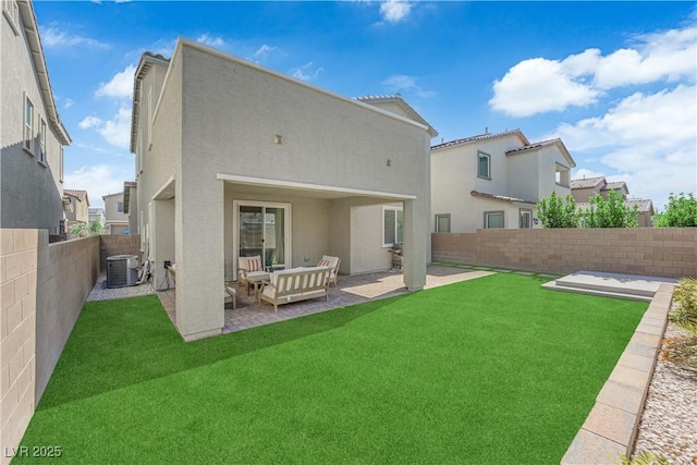 rear view of house featuring stucco siding, a patio area, cooling unit, and an outdoor living space