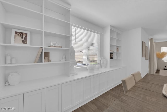 dining area with healthy amount of natural light and wood finished floors