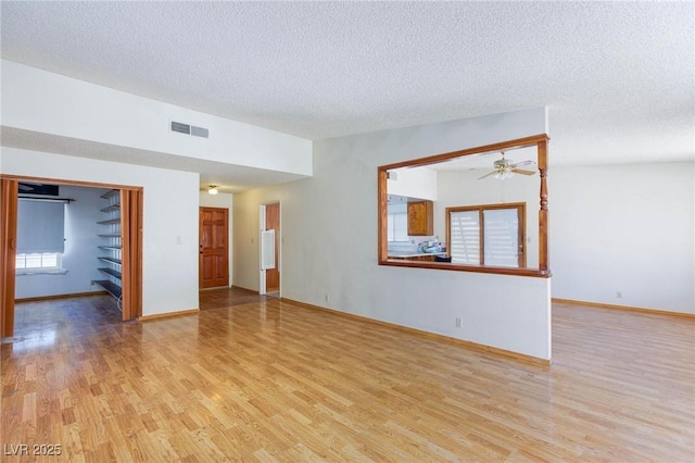 2700 Osborne Ln, Henderson, NV 89014 - spare room with light wood-style floors, a ceiling fan, a textured ceiling, and baseboards