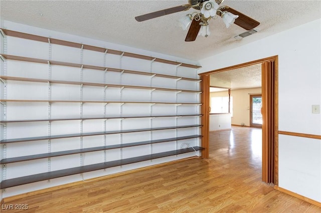 2700 Osborne Ln, Henderson, NV 89014 - empty room featuring a textured ceiling, light wood finished floors, ceiling fan, and baseboards