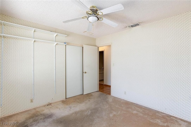 2700 Osborne Ln, Henderson, NV 89014 - unfurnished bedroom featuring carpet floors, a closet, a textured ceiling, and ceiling fan