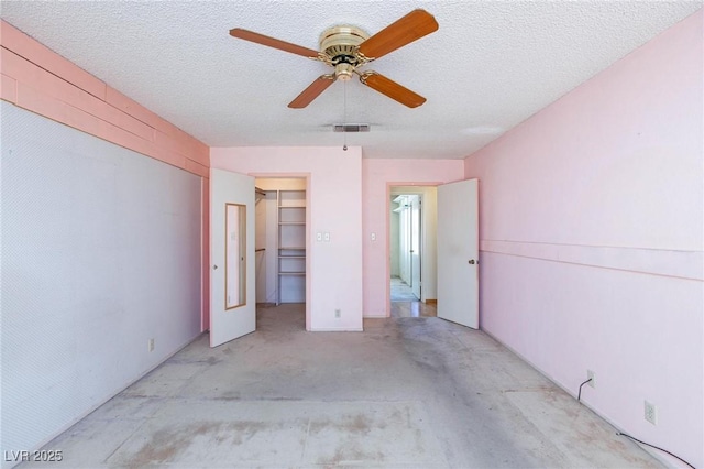 2700 Osborne Ln, Henderson, NV 89014 - unfurnished bedroom with a walk in closet, ceiling fan, a closet, and a textured ceiling