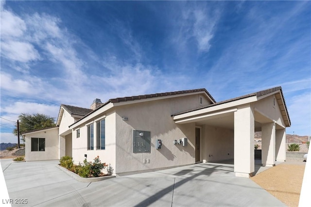 1409 Denver St, Boulder City, NV 89005 - view of front of property with stucco siding and a chimney