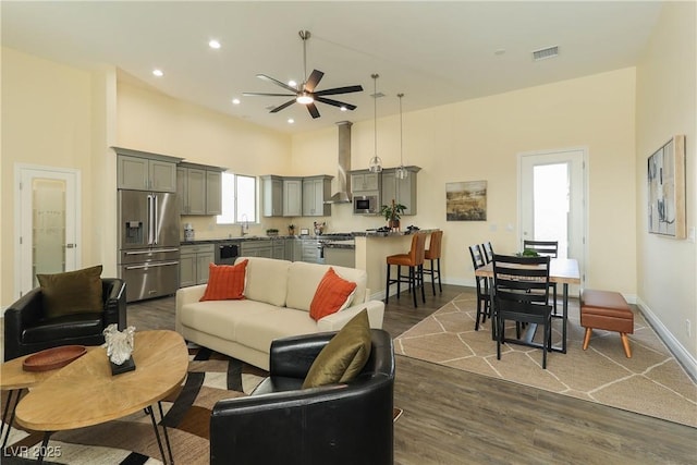 1409 Denver St, Boulder City, NV 89005 - living room with dark wood-style floors, ceiling fan, baseboards, and recessed lighting
