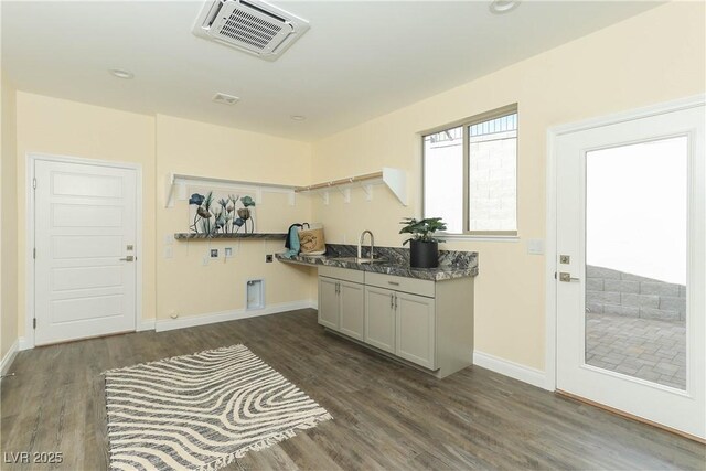 1409 Denver St, Boulder City, NV 89005 - kitchen with dark wood-style flooring, a sink, baseboards, and dark countertops