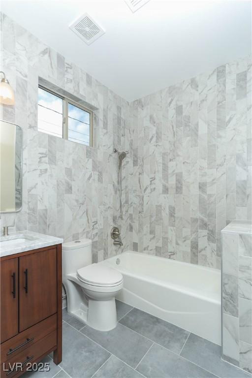 1409 Denver St, Boulder City, NV 89005 - full bath with tub / shower combination, toilet, vanity, tile walls, and tile patterned flooring