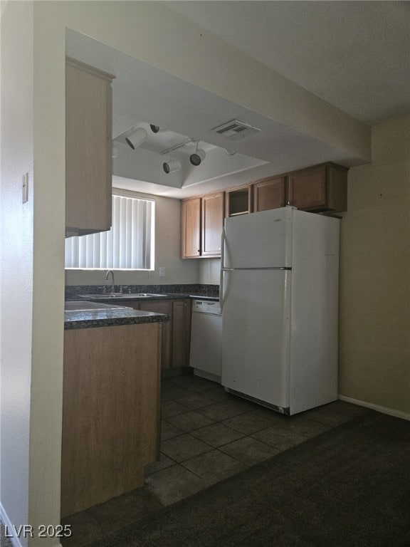 7300 Pirates Cove Rd Unit 2025, Las Vegas, NV 89145 - kitchen featuring white appliances, dark countertops, dark tile patterned flooring, and a sink