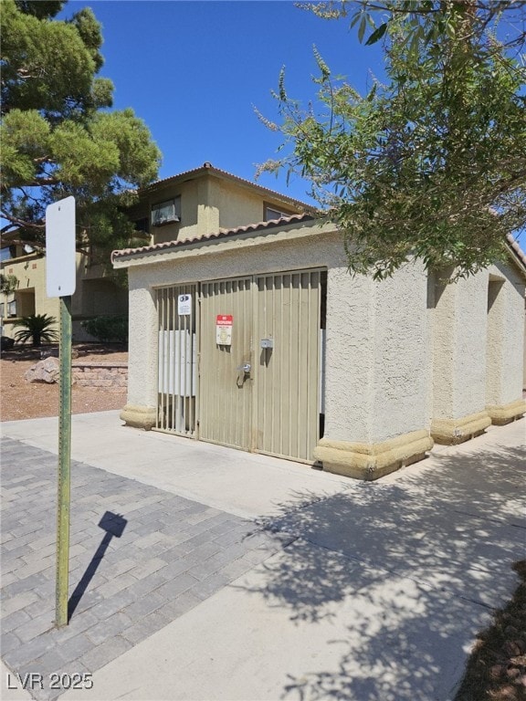 7300 Pirates Cove Rd Unit 2025, Las Vegas, NV 89145 - view of property exterior with stucco siding and a tiled roof