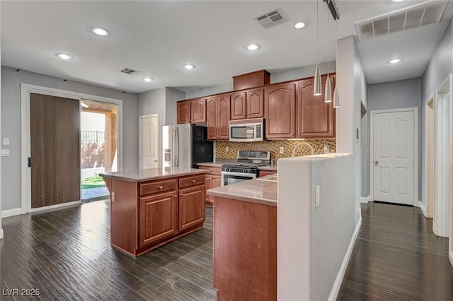 484 Merseyside Dr, Las Vegas, NV 89178 - kitchen with appliances with stainless steel finishes, baseboards, dark wood finished floors, light countertops, and recessed lighting