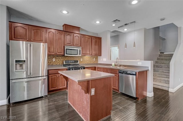484 Merseyside Dr, Las Vegas, NV 89178 - kitchen with stainless steel appliances, baseboards, dark wood finished floors, light countertops, and recessed lighting