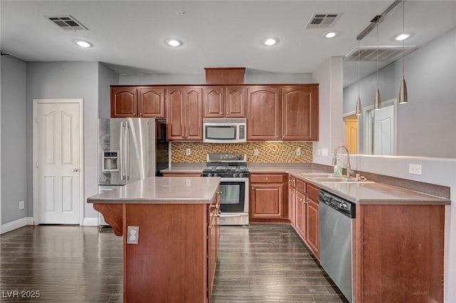 484 Merseyside Dr, Las Vegas, NV 89178 - kitchen featuring stainless steel appliances, dark wood finished floors, a sink, tasteful backsplash, and light countertops