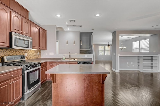 484 Merseyside Dr, Las Vegas, NV 89178 - kitchen with appliances with stainless steel finishes, dark wood-style flooring, a sink, a kitchen island, and baseboards