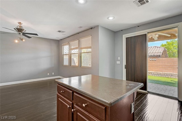 484 Merseyside Dr, Las Vegas, NV 89178 - kitchen featuring a ceiling fan, dark wood-type flooring, baseboards, a kitchen island, and recessed lighting