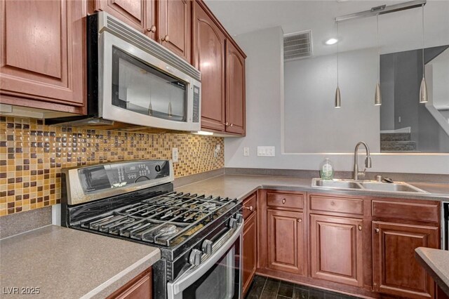484 Merseyside Dr, Las Vegas, NV 89178 - kitchen featuring stainless steel appliances, a sink, backsplash, brown cabinets, and recessed lighting