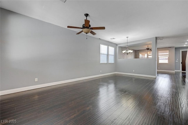 484 Merseyside Dr, Las Vegas, NV 89178 - empty room with ceiling fan, a chandelier, baseboards, and dark wood-style flooring