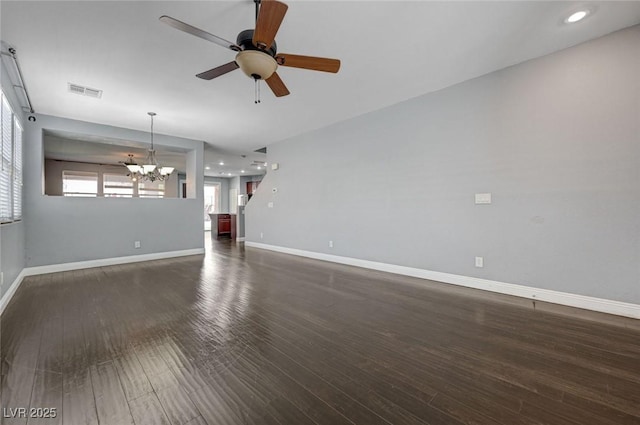 484 Merseyside Dr, Las Vegas, NV 89178 - unfurnished living room featuring a chandelier, ceiling fan, baseboards, dark wood finished floors, and recessed lighting