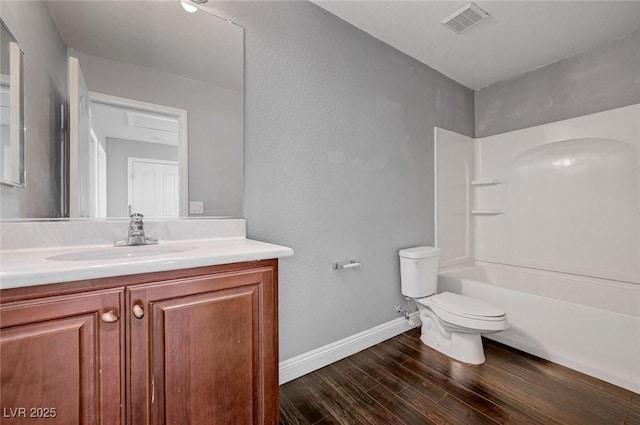 484 Merseyside Dr, Las Vegas, NV 89178 - bathroom featuring toilet, wood finished floors, vanity, baseboards, and tub / shower combination