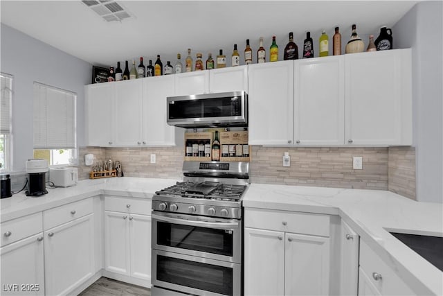 9141 Careful Canvas Ave, Las Vegas, NV 89149 - kitchen featuring stainless steel appliances and white cabinets