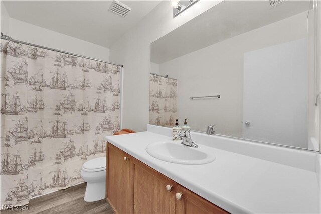 9141 Careful Canvas Ave, Las Vegas, NV 89149 - full bathroom featuring wood finished floors, toilet, vanity, and a shower with curtain