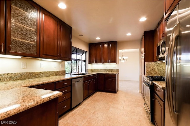 1440 Rawhide Rd, Boulder City, NV 89005 - kitchen with appliances with stainless steel finishes, recessed lighting, light stone countertops, backsplash, and a chandelier