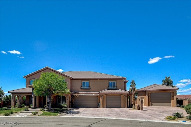 1182 Thomas Bay Cir, Logandale, NV 89021 - view of front of property featuring driveway, a tile roof, stucco siding, and an attached garage