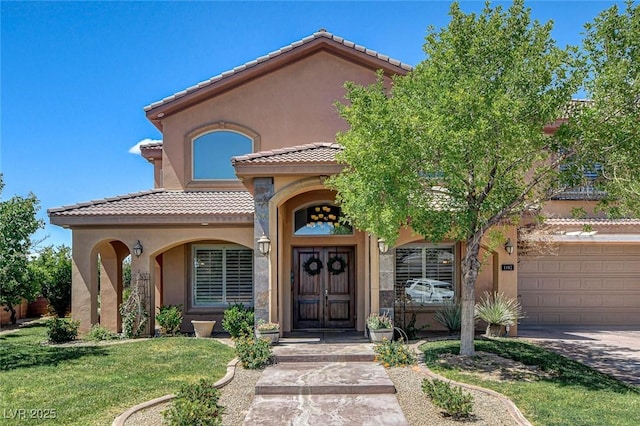 1182 Thomas Bay Cir, Logandale, NV 89021 - view of front of home featuring stucco siding, a tile roof, driveway, a garage, and a front yard