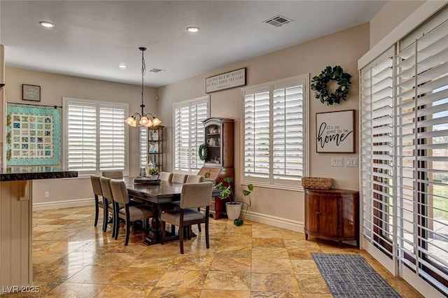 1182 Thomas Bay Cir, Logandale, NV 89021 - dining area with baseboards, a chandelier, recessed lighting, and light stone finish floors