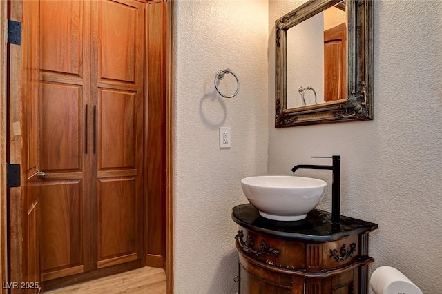 1182 Thomas Bay Cir, Logandale, NV 89021 - bathroom featuring a textured wall, wood finished floors, and vanity