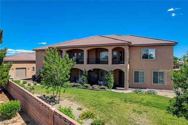 1182 Thomas Bay Cir, Logandale, NV 89021 - mediterranean / spanish house featuring stucco siding, a tile roof, a balcony, and a garage
