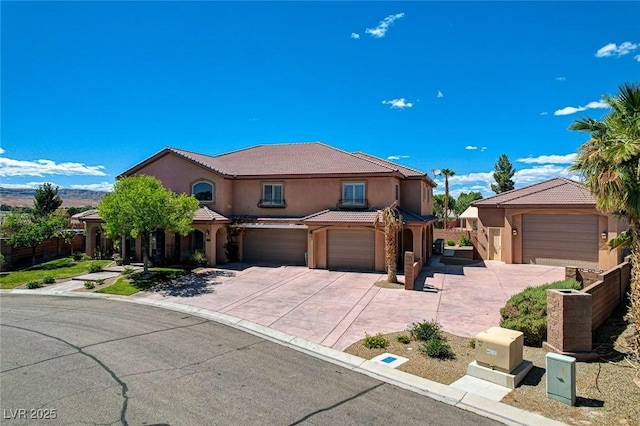 1182 Thomas Bay Cir, Logandale, NV 89021 - mediterranean / spanish-style house with stucco siding, concrete driveway, an attached garage, and a tiled roof