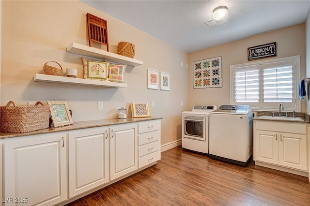 1182 Thomas Bay Cir, Logandale, NV 89021 - washroom featuring washing machine and clothes dryer, cabinet space, dark wood-style flooring, and baseboards
