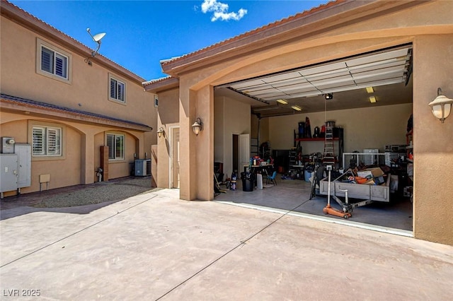 1182 Thomas Bay Cir, Logandale, NV 89021 - garage with central AC unit, driveway, and a garage door opener