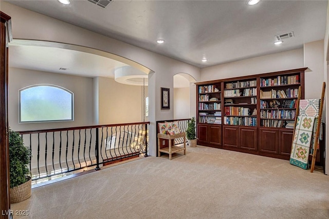 1182 Thomas Bay Cir, Logandale, NV 89021 - sitting room featuring carpet, arched walkways, and recessed lighting