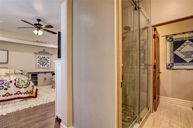 1182 Thomas Bay Cir, Logandale, NV 89021 - full bathroom with a ceiling fan, a stall shower, and baseboards