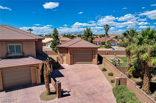 1182 Thomas Bay Cir, Logandale, NV 89021 - mediterranean / spanish house with stucco siding, a garage, fence, and a tile roof