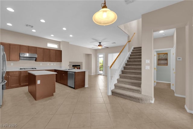 11237 Newbury Hills Ave, Las Vegas, NV 89138 - kitchen with extractor fan, stainless steel appliances, light countertops, open floor plan, and a center island