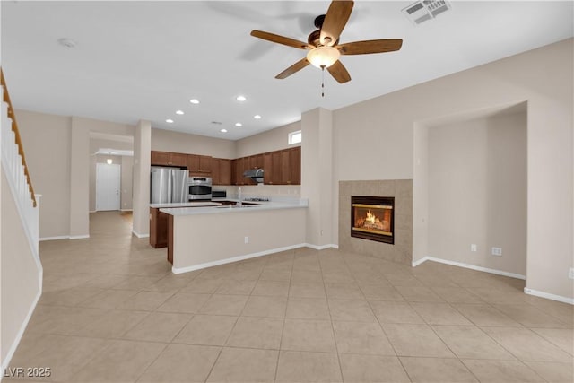 11237 Newbury Hills Ave, Las Vegas, NV 89138 - kitchen featuring appliances with stainless steel finishes, open floor plan, light countertops, ceiling fan, and light tile patterned floors
