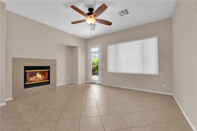 11237 Newbury Hills Ave, Las Vegas, NV 89138 - unfurnished living room featuring a tiled fireplace, a ceiling fan, and light tile patterned floors