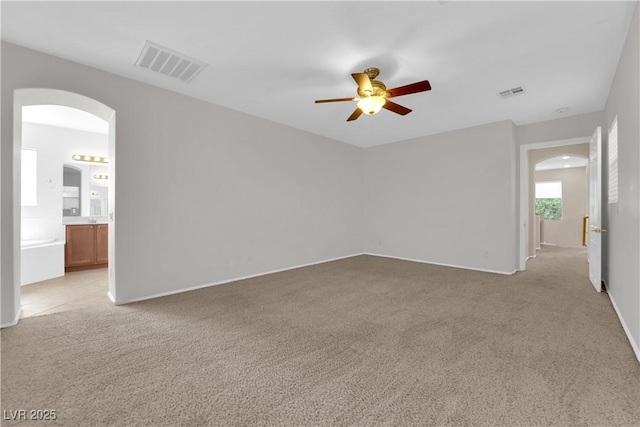 11237 Newbury Hills Ave, Las Vegas, NV 89138 - spare room featuring arched walkways, a ceiling fan, and light carpet