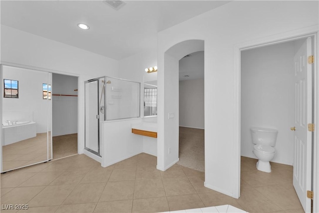 11237 Newbury Hills Ave, Las Vegas, NV 89138 - unfurnished bedroom with arched walkways, tile patterned floors, connected bathroom, and recessed lighting
