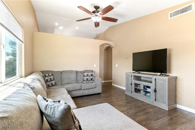 7553 Durham Hall Ave Unit 201, Las Vegas, NV 89130 - living room featuring vaulted ceiling, wood finished floors, arched walkways, ceiling fan, and baseboards