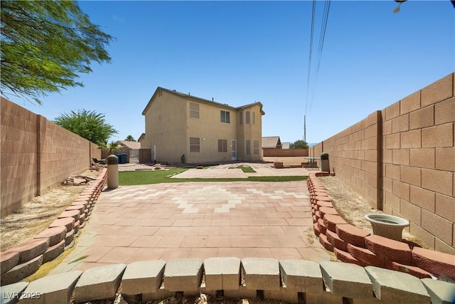 6088 Gulf Island Ave, Las Vegas, NV 89156 - rear view of property featuring a fenced backyard and a patio area