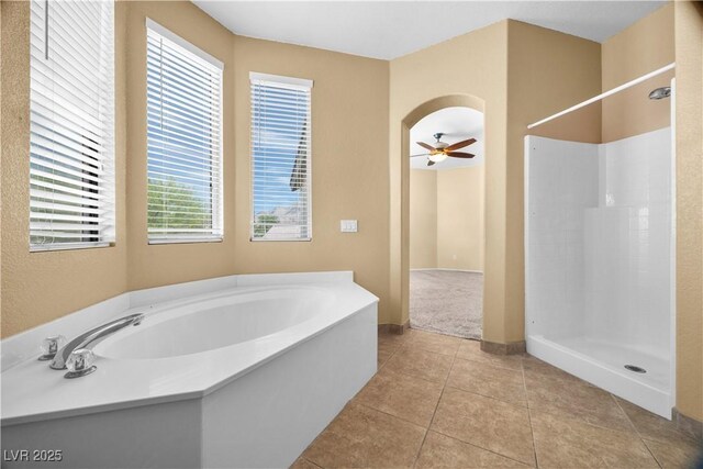 6088 Gulf Island Ave, Las Vegas, NV 89156 - full bathroom with walk in shower, a ceiling fan, a garden tub, tile patterned floors, and baseboards