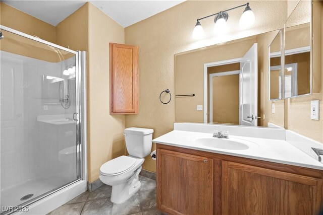 6088 Gulf Island Ave, Las Vegas, NV 89156 - bathroom featuring a shower stall, toilet, a textured wall, and vanity